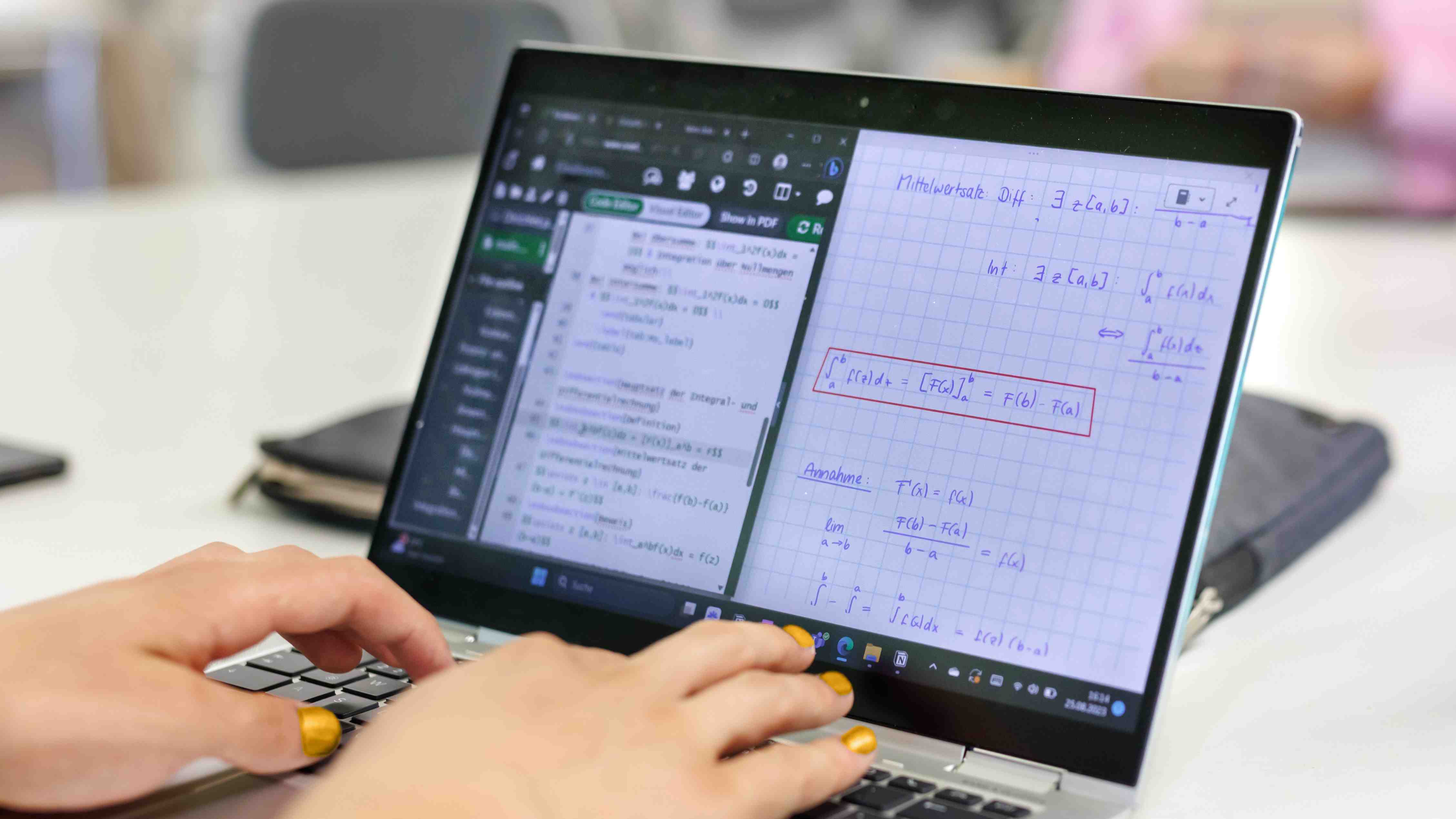 Ein Laptop mit mathematischen Symbolen, Hände, die auf der Tastatur tippen
